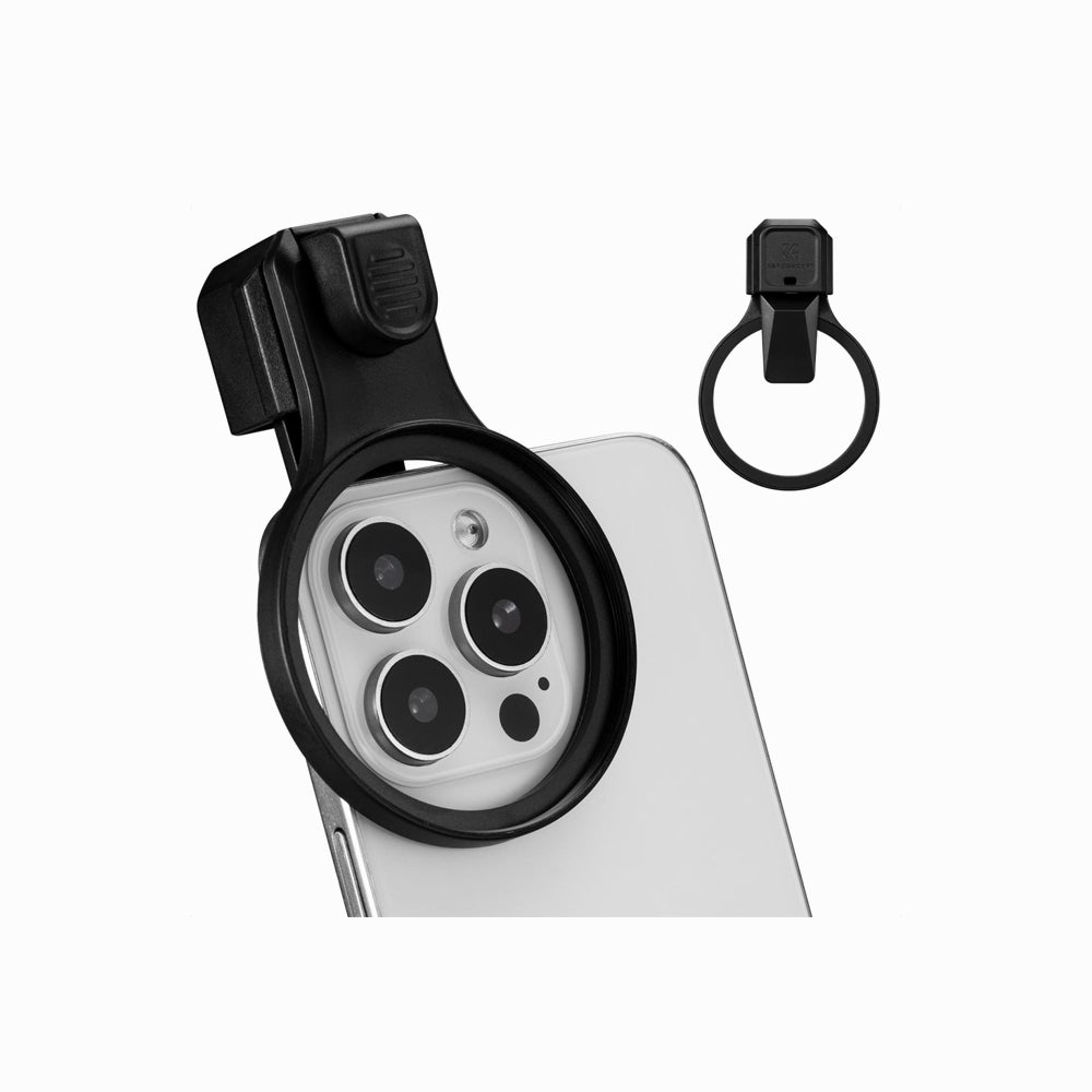 A black camera lens attachment clip shown mounted over a smartphone camera module, with a separate matching ring clip displayed to the right on a clean white background.